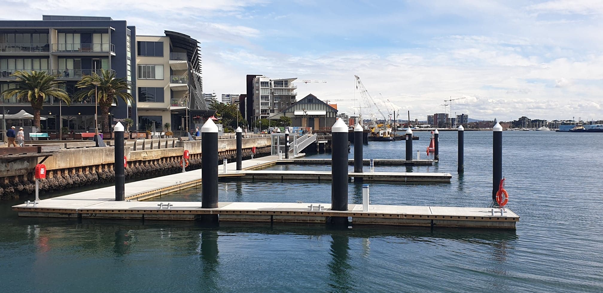 Dock pontoons with Newcastle's waterfront skyline behind